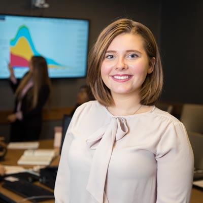 A student poses for a photo in the College of Business at MU.